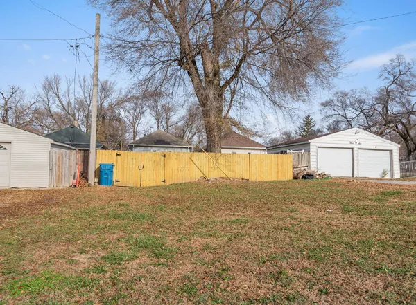 a view of a large white house with a yard