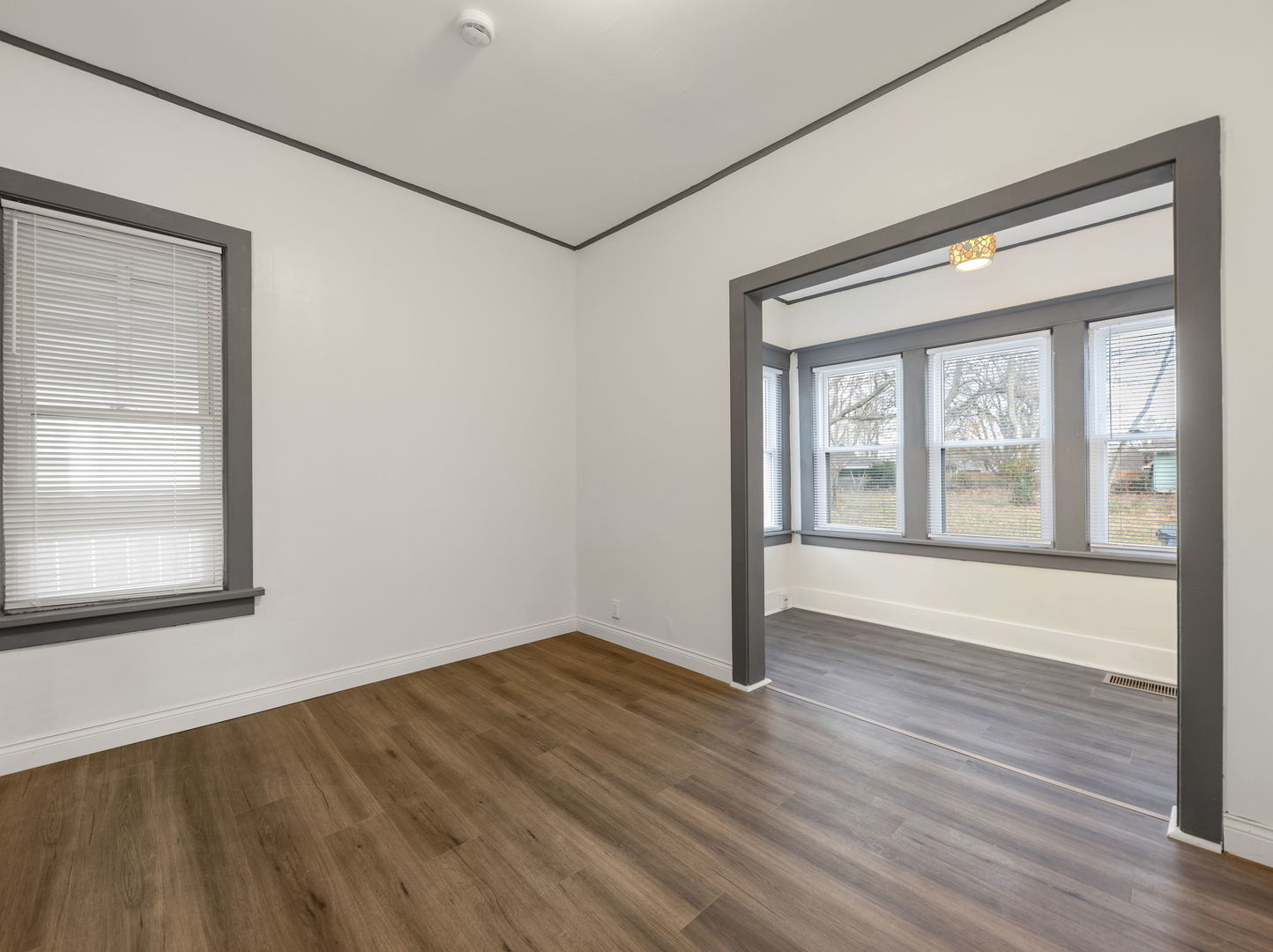 312 West Stone Street Kankakee, IL 60901 - Photo 4 of 17 a view of an empty room with wooden floor and a window