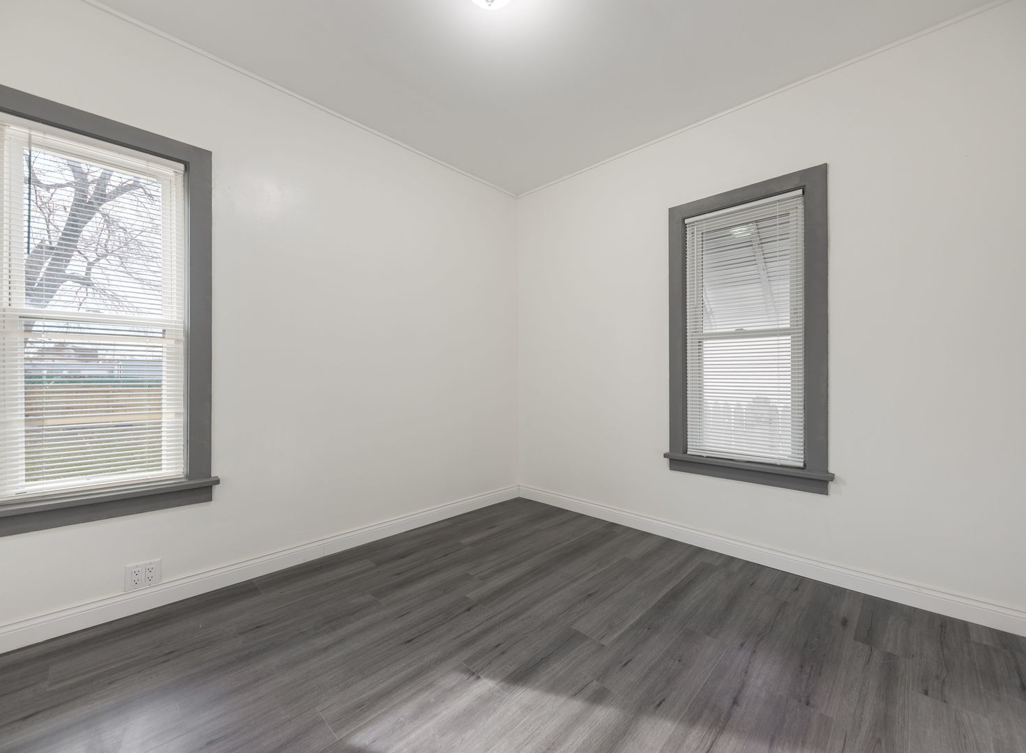 312 West Stone Street Kankakee, IL 60901 - Photo 5 of 17 a view of an empty room with wooden floor and a window