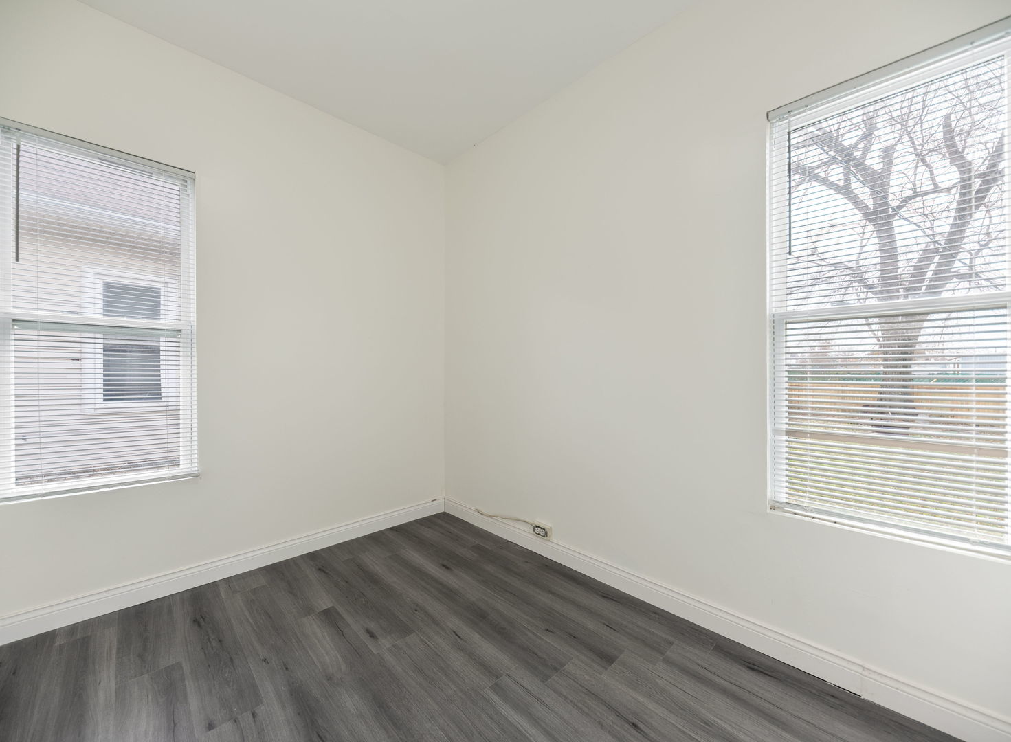 312 West Stone Street Kankakee, IL 60901 - Photo 6 of 17 a view of an empty room with wooden floor and a window