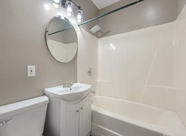 a bathroom with a sink a mirror and a bathtub