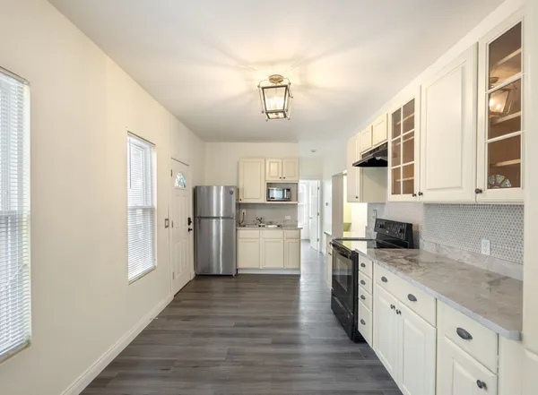 a kitchen with stainless steel appliances a refrigerator sink and cabinets