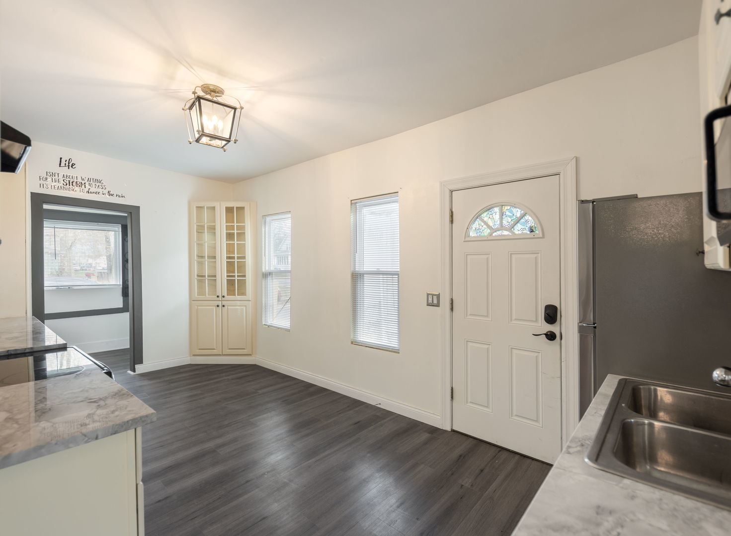 312 West Stone Street Kankakee, IL 60901 - Photo 9 of 17 a view of a livingroom with wooden floor and kitchen space