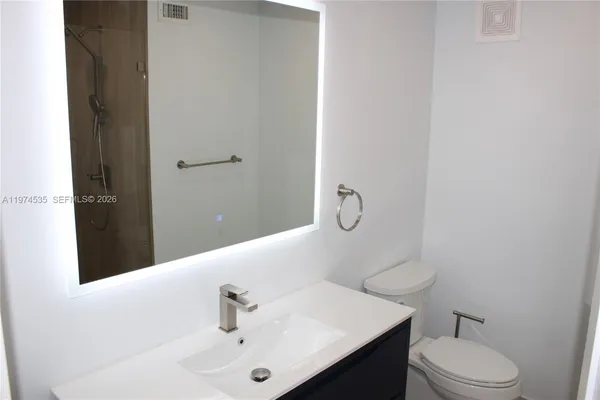 a bathroom with a glass shower door