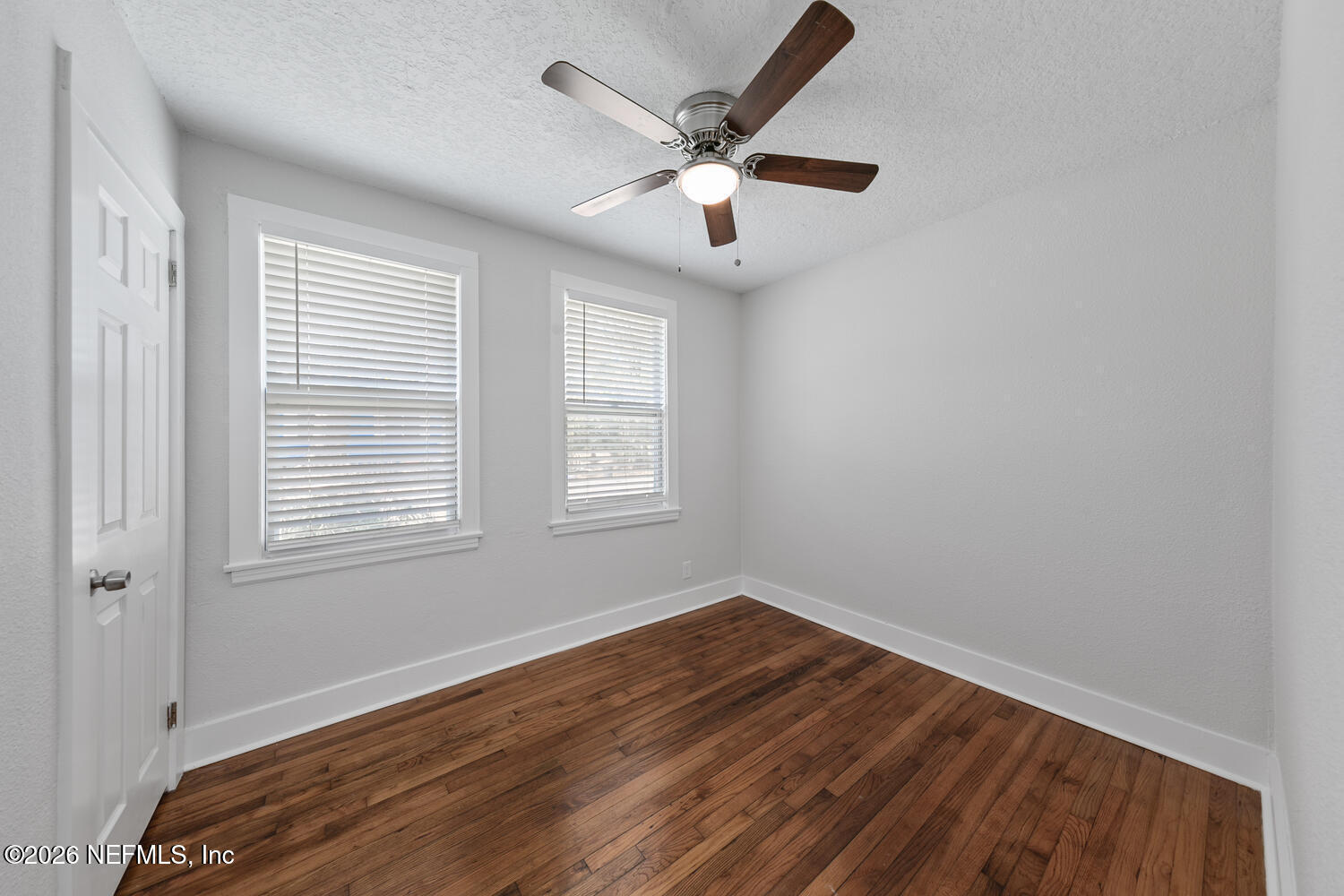 715 Ralph Street Jacksonville, FL 32204 - Photo 14 of 21 an empty room with wooden floor chandelier fan and windows