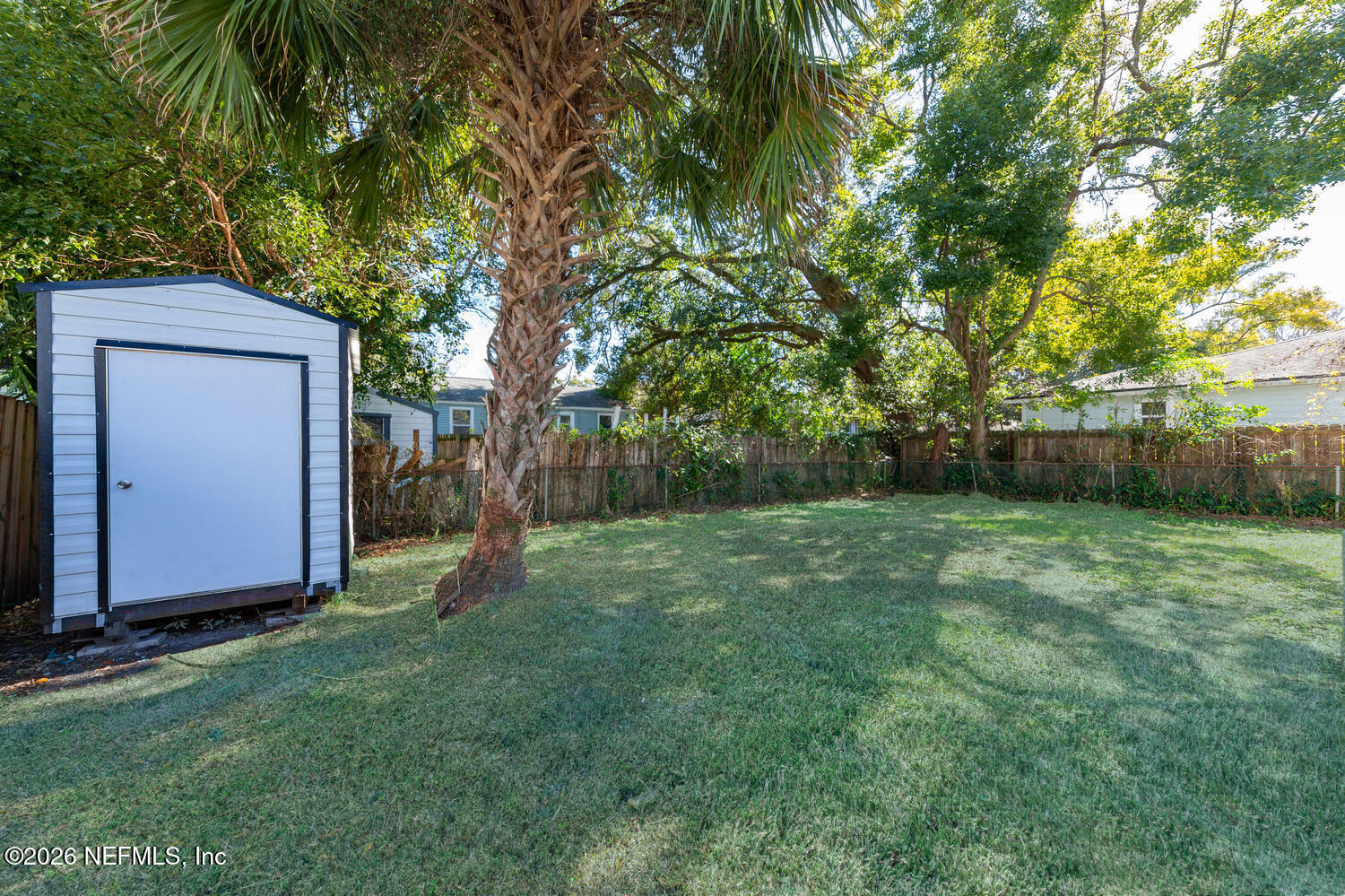 715 Ralph Street Jacksonville, FL 32204 - Photo 20 of 21 a view of backyard with large trees and wooden fence