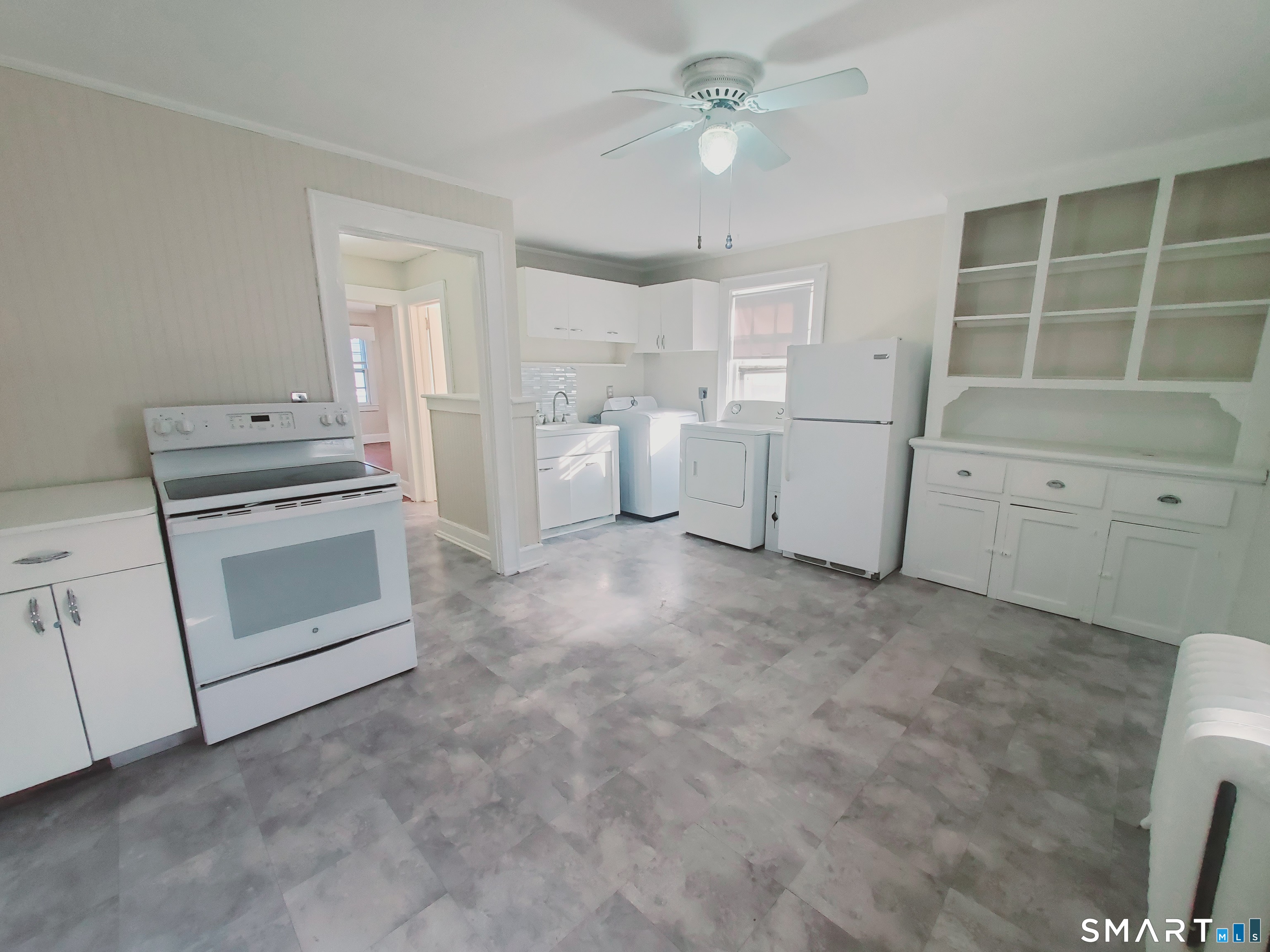 a kitchen with white cabinets and white appliances