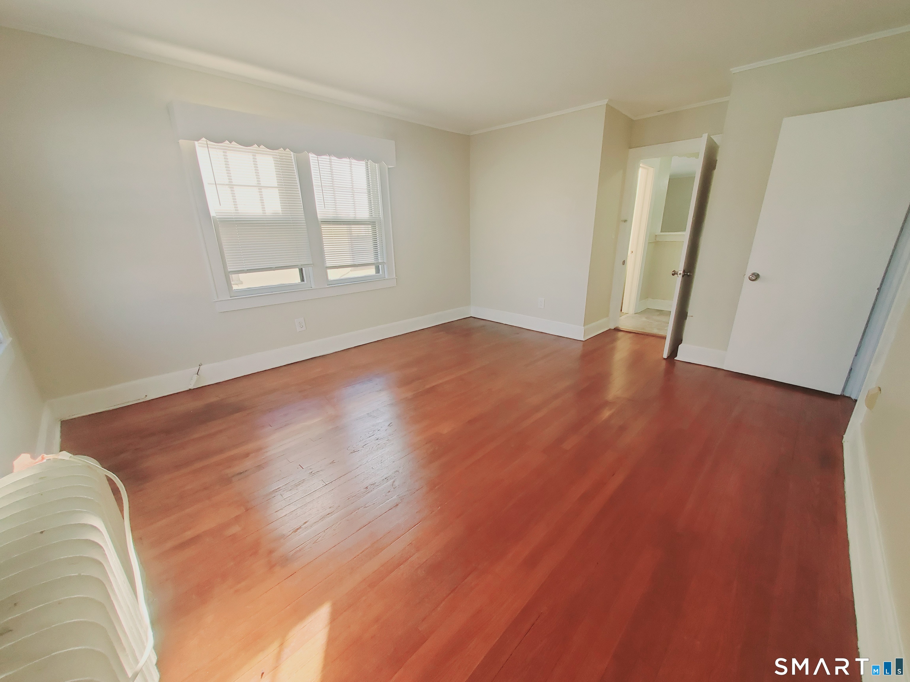 156 River Rd Extension, Unit 3 Greenwich, CT 06807 - Photo 2 of 9 an empty room with wooden floor and windows