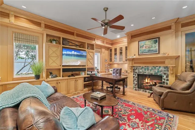 a living room with furniture fireplace and flat screen tv
