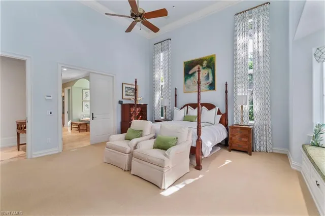 a spacious bedroom with a bed and a chandelier