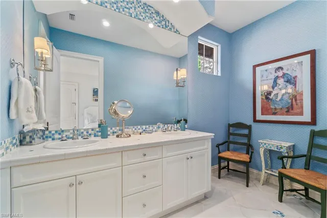a bathroom with a double vanity sink and a mirror
