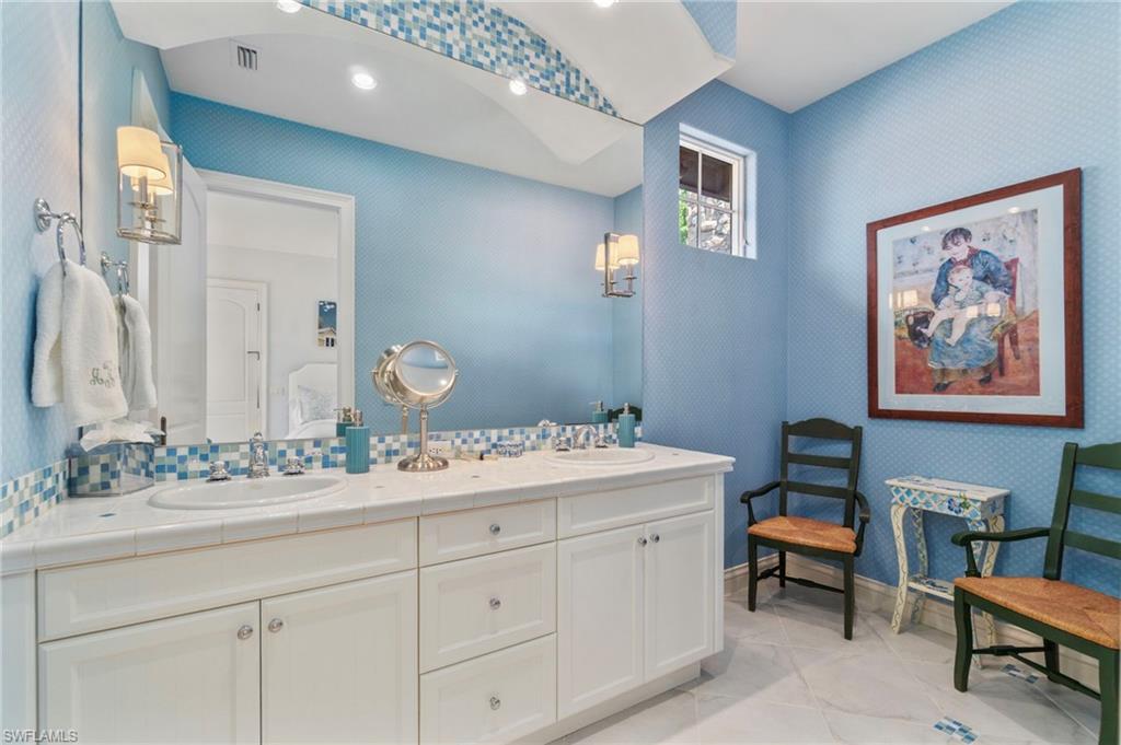 29150 Positano Lane Naples, FL 34110 - Photo 21 of 50 a bathroom with a double vanity sink and a mirror