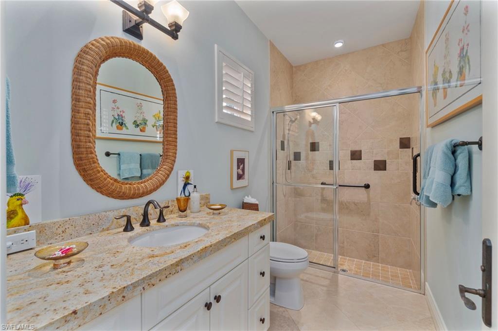 29150 Positano Lane Naples, FL 34110 - Photo 22 of 50 a bathroom with a granite countertop sink mirror toilet and shower