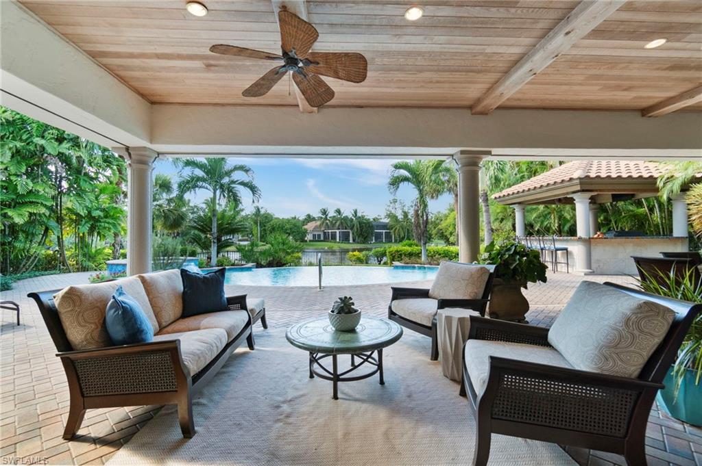 29150 Positano Lane Naples, FL 34110 - Photo 26 of 50 a outdoor space with patio the couches and a dining table with garden view