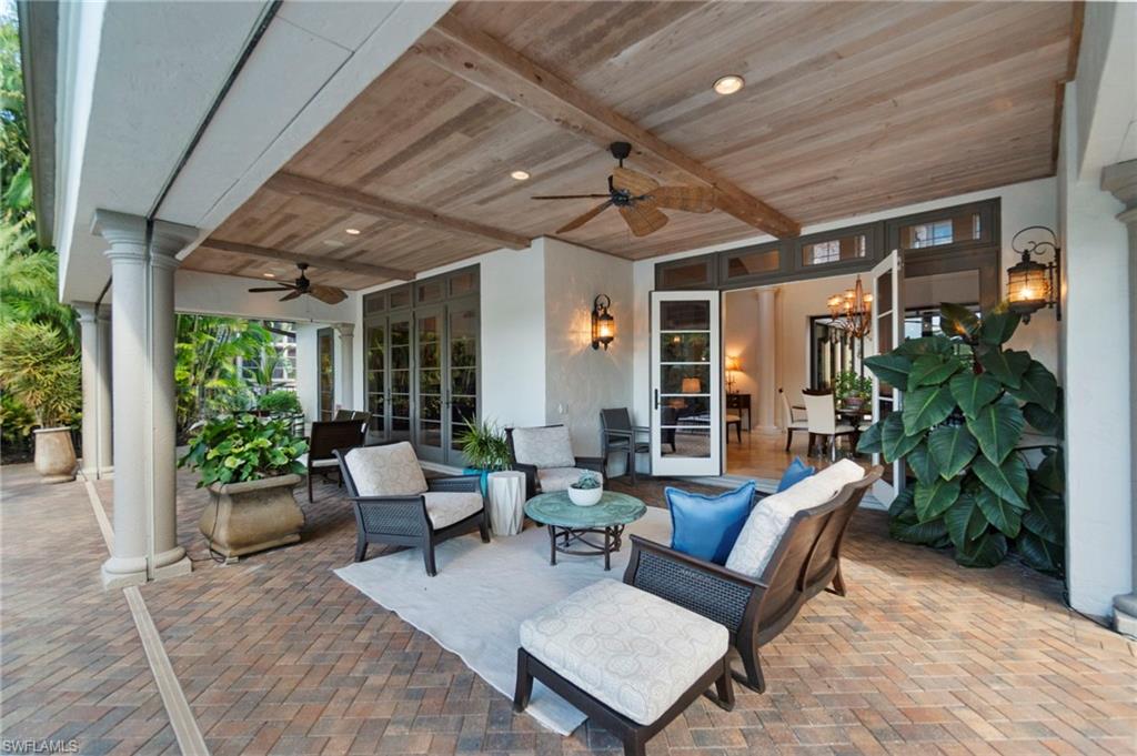 29150 Positano Lane Naples, FL 34110 - Photo 27 of 50 a building outdoor space with patio furniture and potted plants