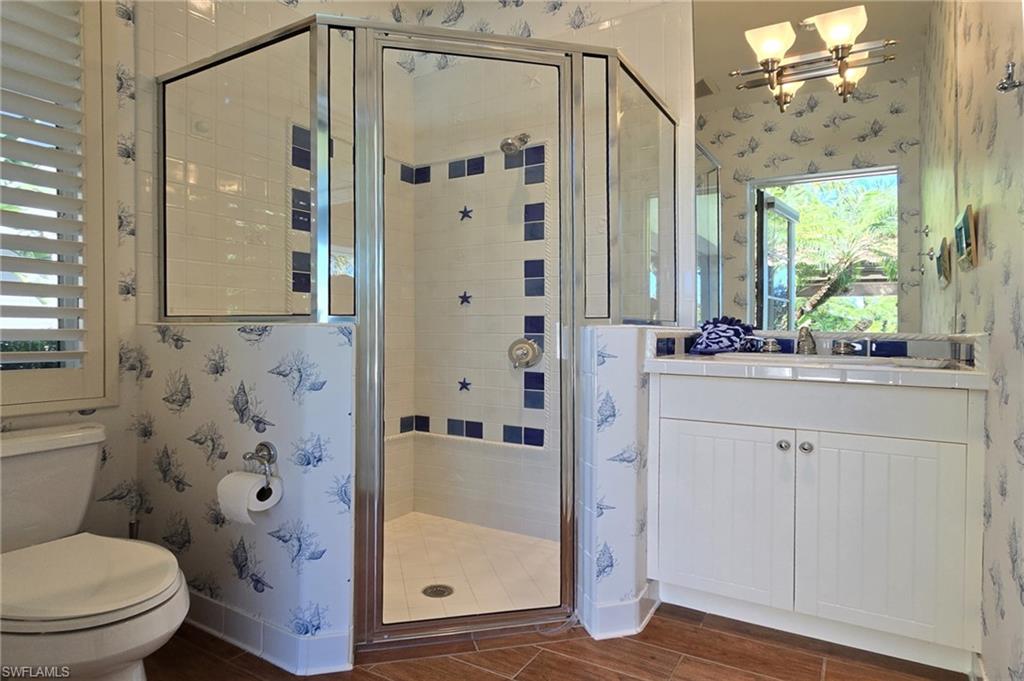 29150 Positano Lane Naples, FL 34110 - Photo 33 of 50 a bathroom with a shower a sink and a mirror with toilet