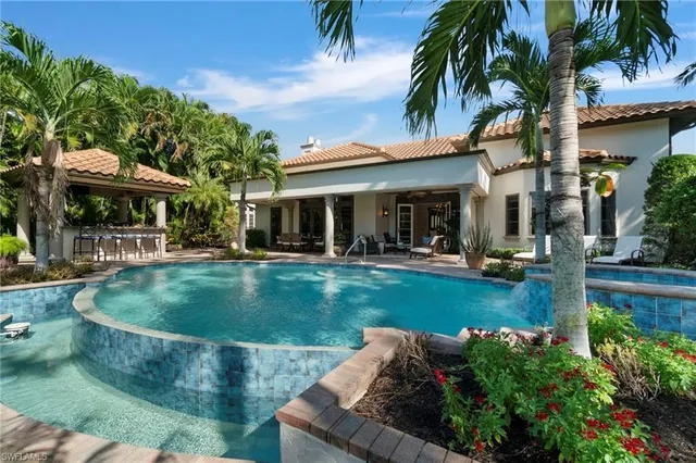 a view of a house with swimming pool and sitting area