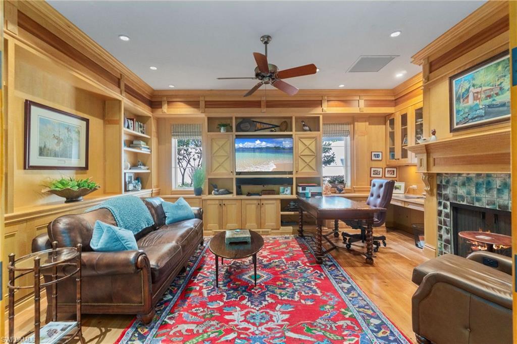 29150 Positano Lane Naples, FL 34110 - Photo 10 of 50 a living room with furniture a fireplace and a flat screen tv