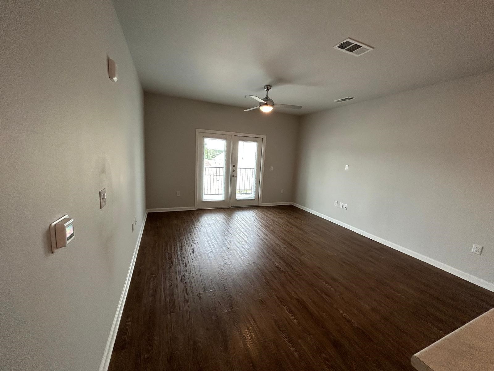 2136 West 34th Street, Unit 135 Houston, TX 77018 - Photo 7 of 8 an empty room with wooden floor and windows