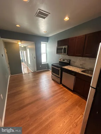 a kitchen with granite countertop a stove and a sink