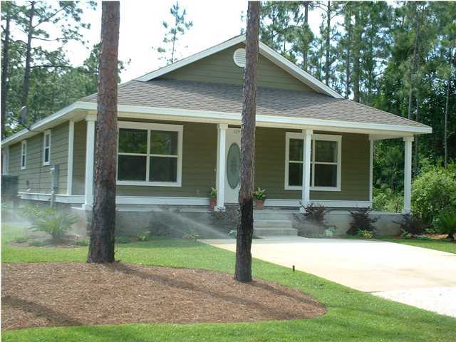 119 North 3rd Street Santa Rosa Beach, FL 32459 - Photo 2 of 18 a front view of a house with garden