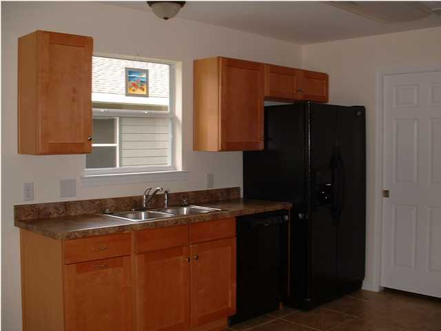 119 North 3rd Street Santa Rosa Beach, FL 32459 - Photo 17 of 18 a kitchen with a sink and a refrigerator