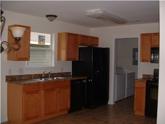 119 North 3rd Street Santa Rosa Beach, FL 32459 - Photo 9 of 18 a kitchen with a refrigerator and a sink
