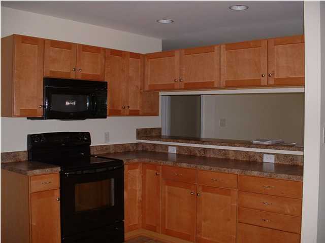 119 North 3rd Street Santa Rosa Beach, FL 32459 - Photo 10 of 18 a kitchen with granite countertop a stove and a microwave
