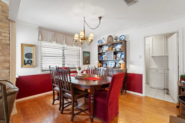 a kitchen with stainless steel appliances granite countertop a sink dishwasher stove and refrigerator with wooden floor