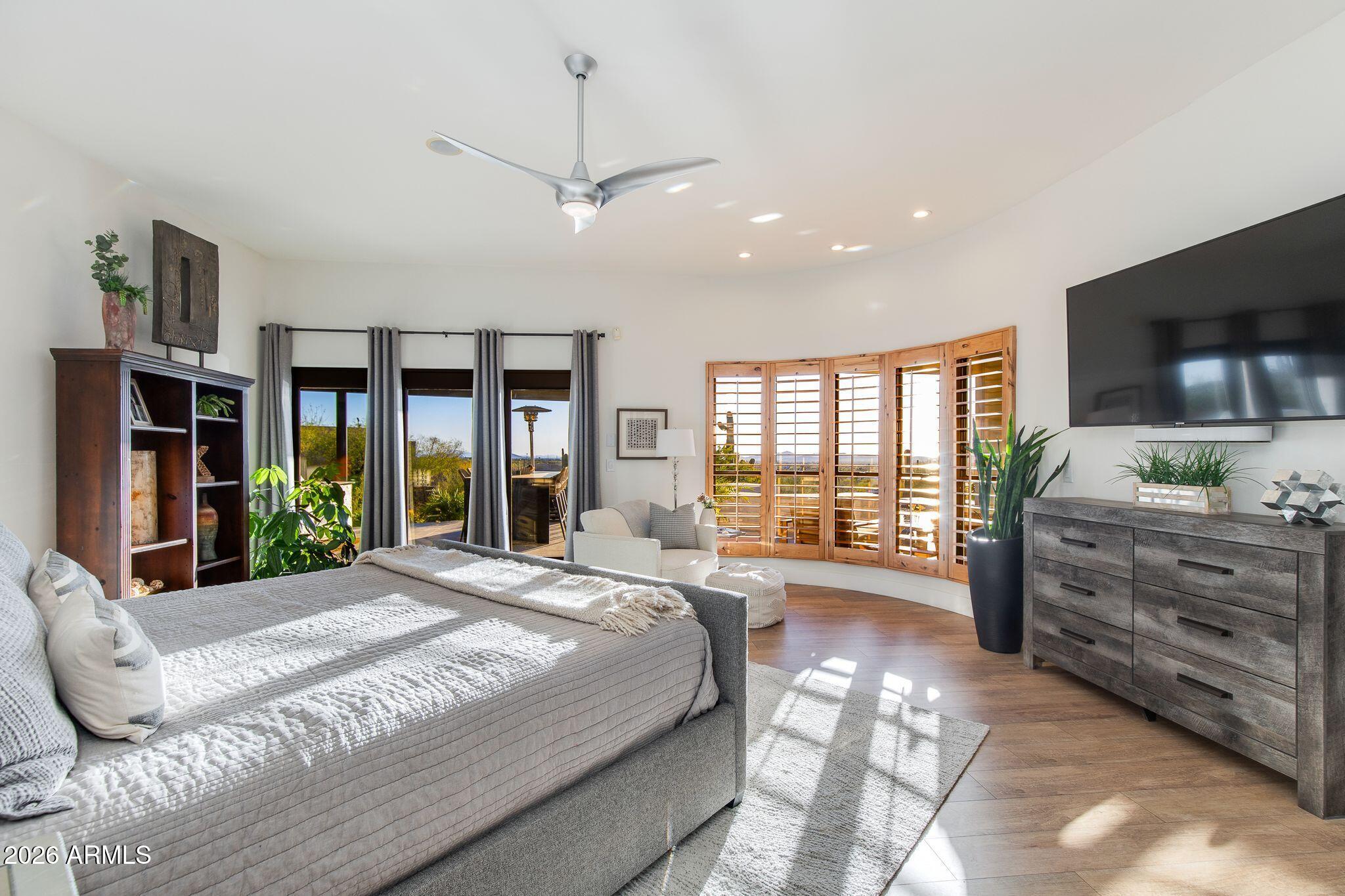 5901 East Restin Road Cave Creek, AZ 85331 - Photo 32 of 101 a spacious bedroom with a large bed and a flat tv screen