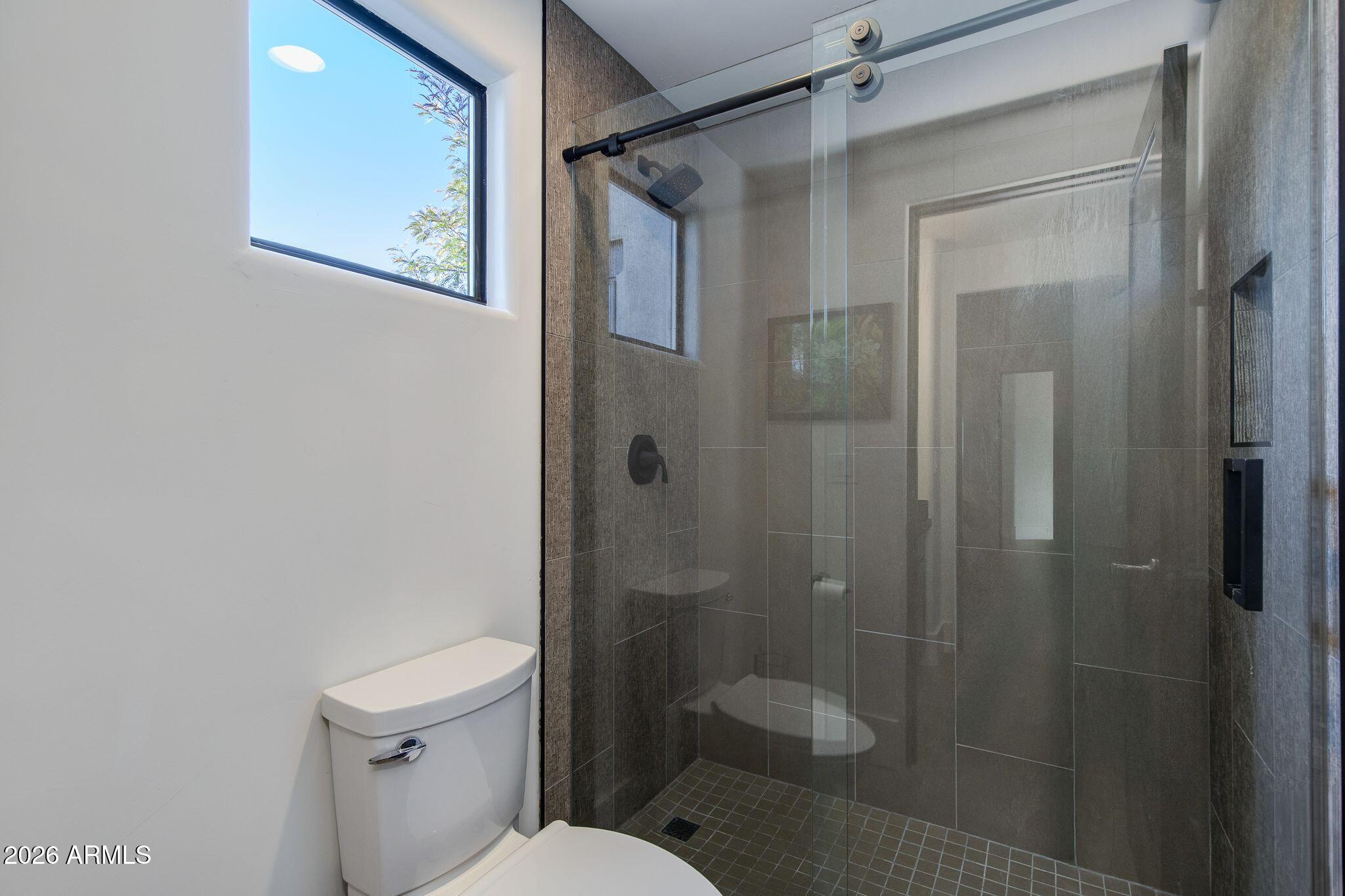 5901 East Restin Road Cave Creek, AZ 85331 - Photo 44 of 101 a bathroom with a shower and toilet