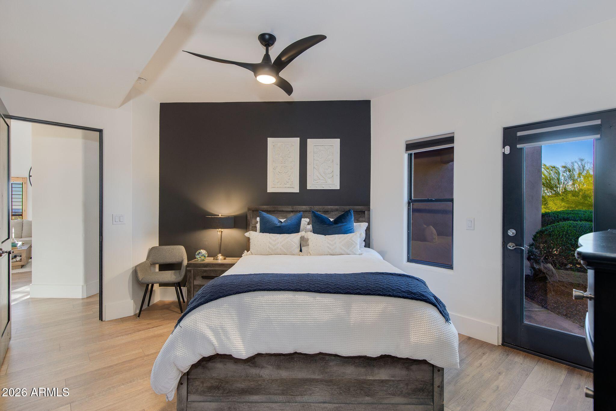 5901 East Restin Road Cave Creek, AZ 85331 - Photo 46 of 101 a bedroom with a bed and wooden floor