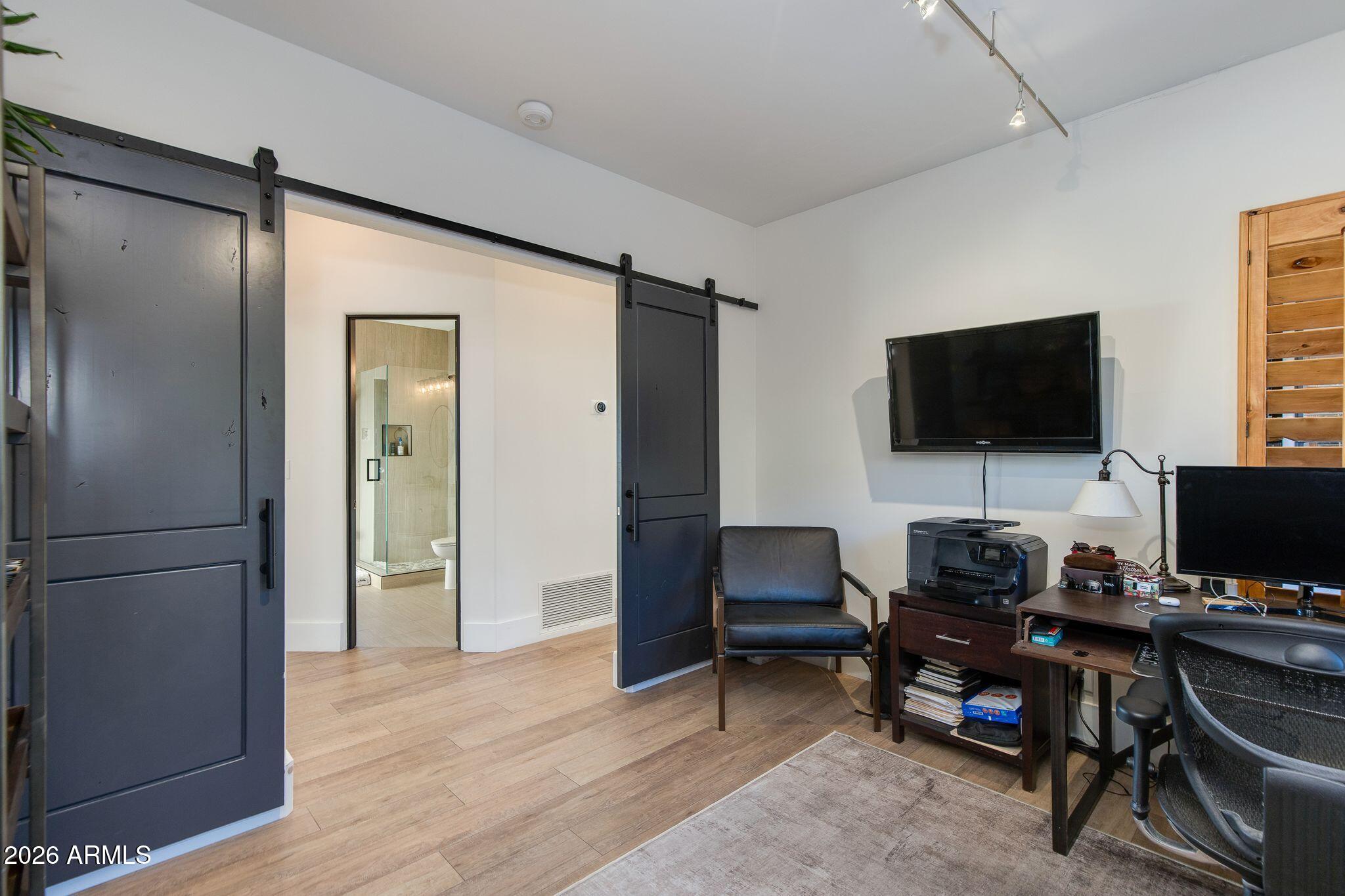 5901 East Restin Road Cave Creek, AZ 85331 - Photo 48 of 101 a view of a workspace with furniture and a flat screen tv