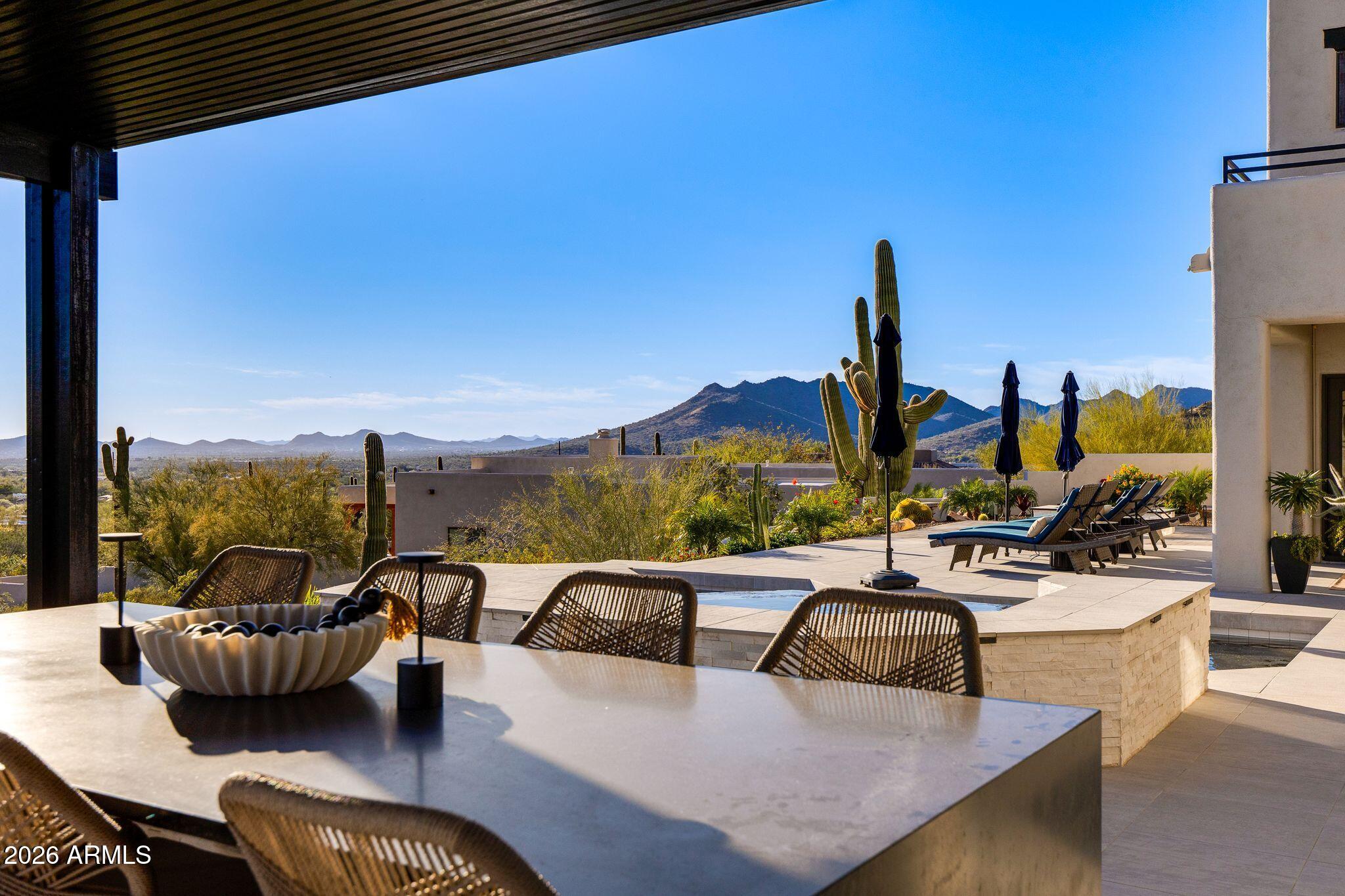 5901 East Restin Road Cave Creek, AZ 85331 - Photo 83 of 101 a view of a roof deck with couches and potted plants