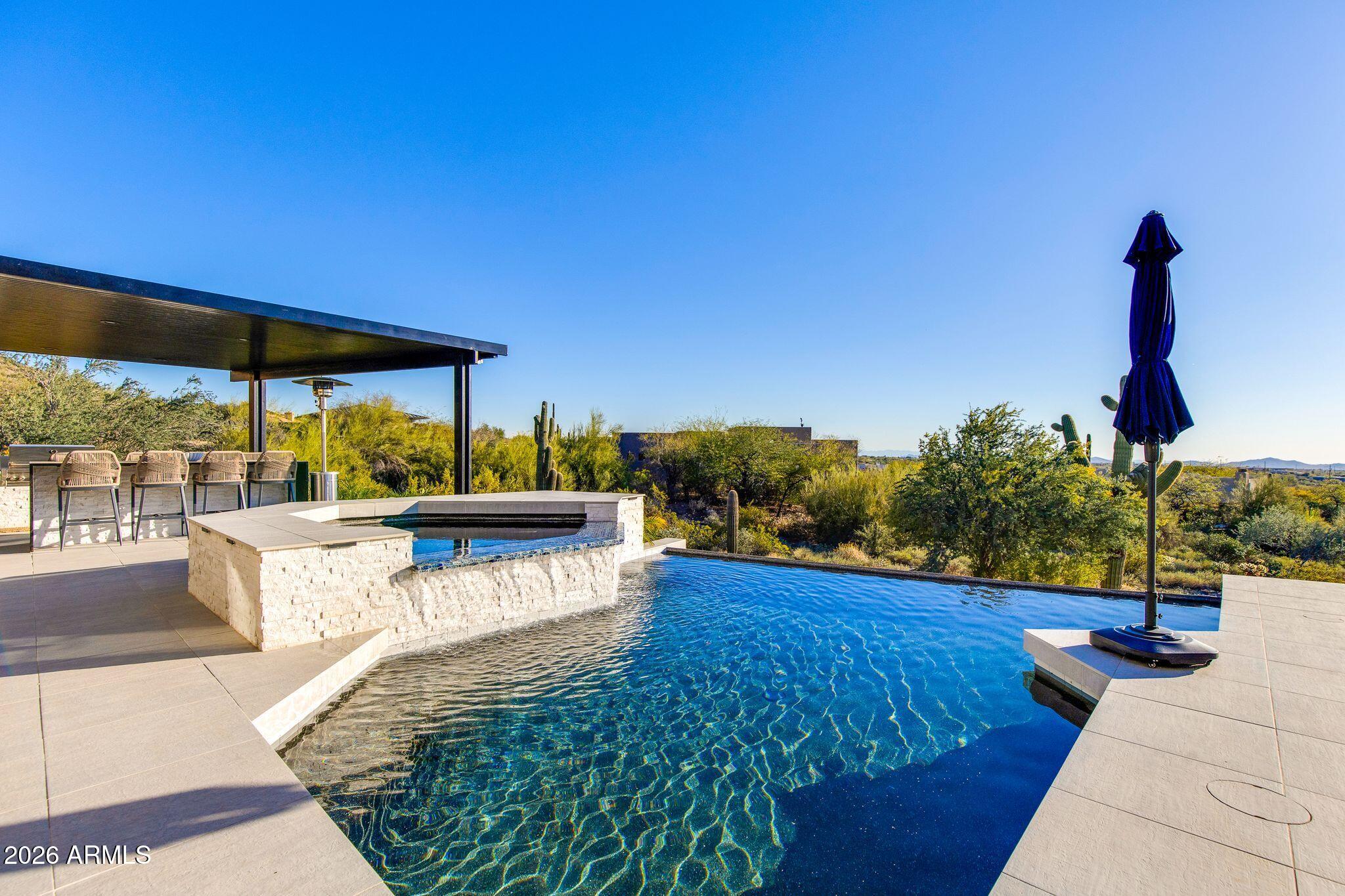5901 East Restin Road Cave Creek, AZ 85331 - Photo 85 of 101 a view of a swimming pool with a patio