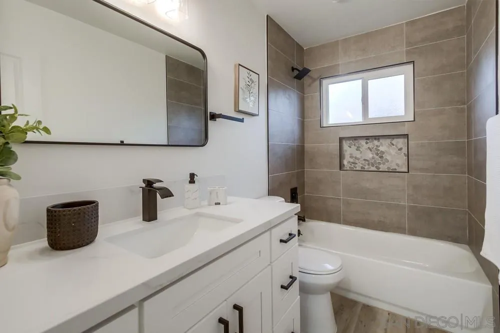 1839 Yettford Road Vista, CA 92083 - Photo 19 of 42 a bathroom with a sink a toilet and shower