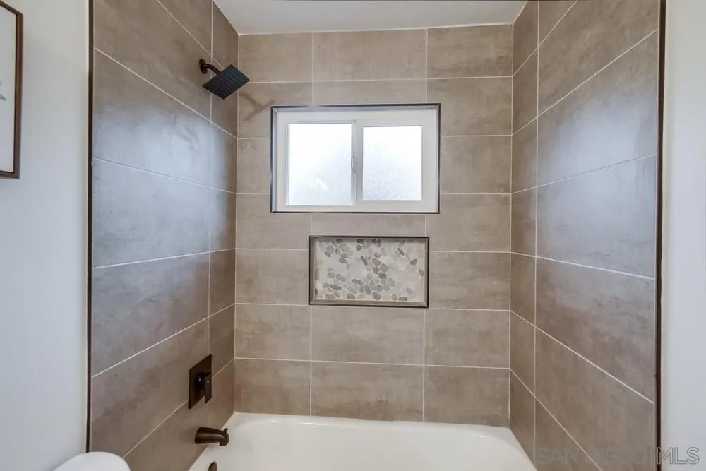 1839 Yettford Road Vista, CA 92083 - Photo 20 of 42 a bathroom with a window and a shower