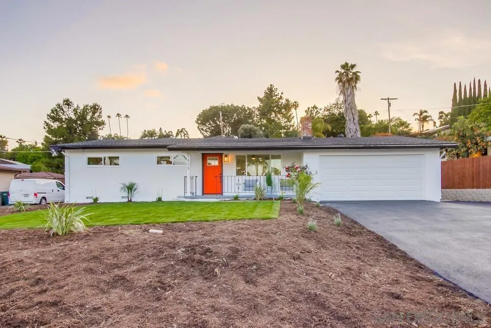 1839 Yettford Road Vista, CA 92083 - Photo 2 of 42 a view of a house with a yard and table and chairs under an umbrella
