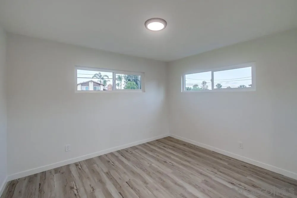 1839 Yettford Road Vista, CA 92083 - Photo 21 of 42 a view of empty room with wooden floor and fan