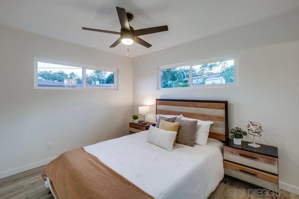 1839 Yettford Road Vista, CA 92083 - Photo 23 of 42 a bedroom with a bed and a chandelier