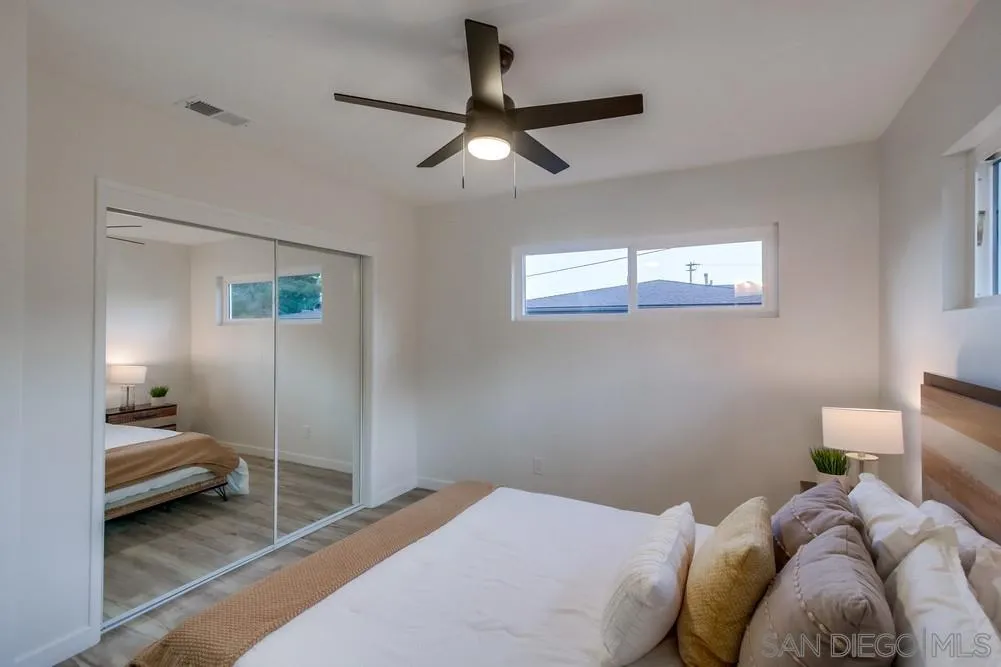 1839 Yettford Road Vista, CA 92083 - Photo 24 of 42 a bedroom with a bed and a chandelier