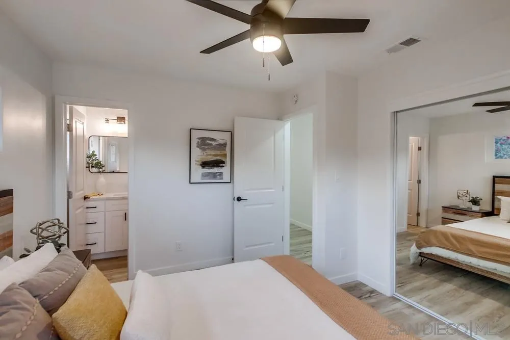 1839 Yettford Road Vista, CA 92083 - Photo 27 of 42 a bedroom with furniture and a chandelier