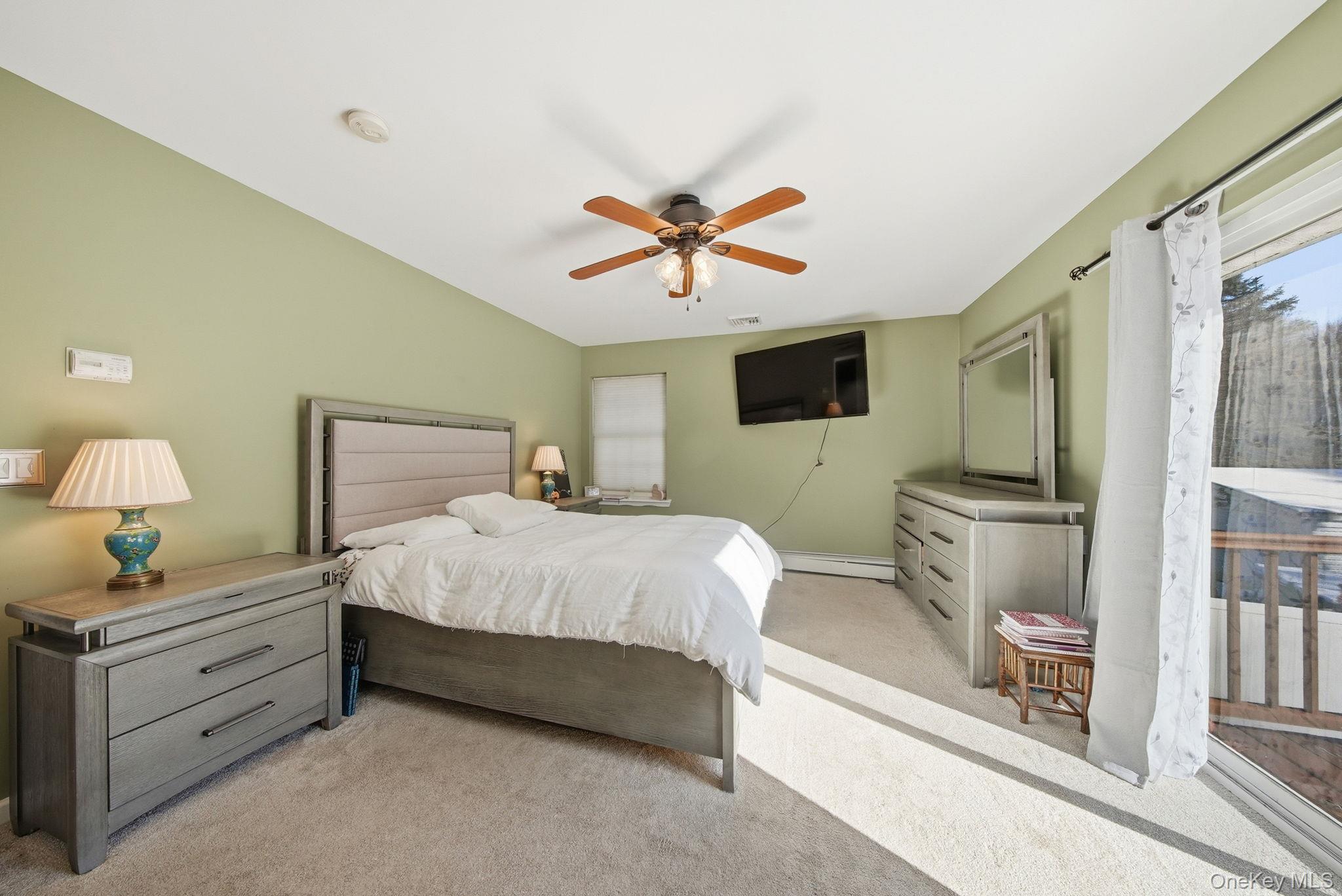 100 Maybrook Road Campbell Hall, NY 10916 - Photo 11 of 32 a bedroom with a bed and a chandelier