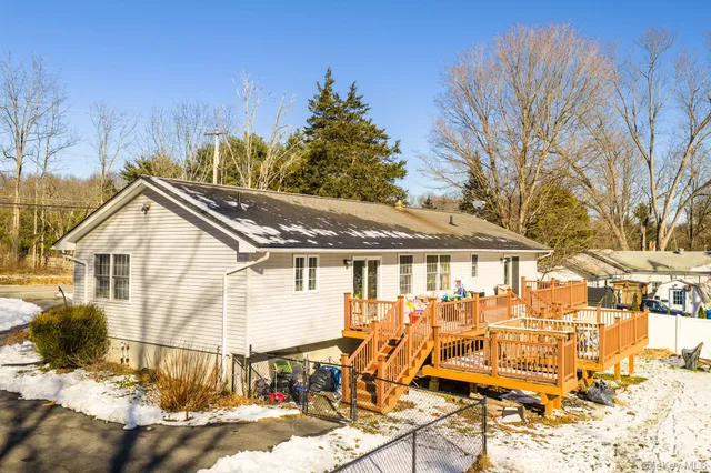 a view of a house with a patio and wooden fence