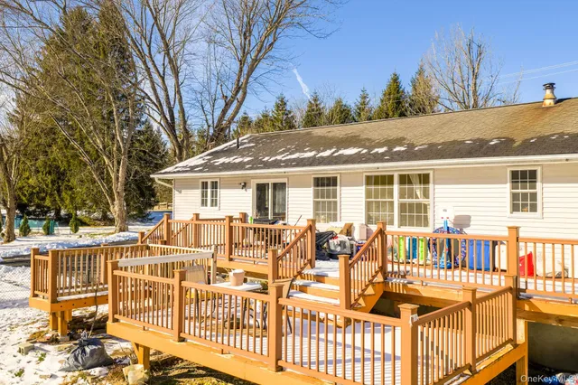 a porch with a bench next to a yard