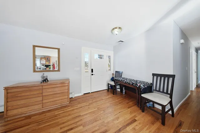 a bedroom with furniture and a wooden floor