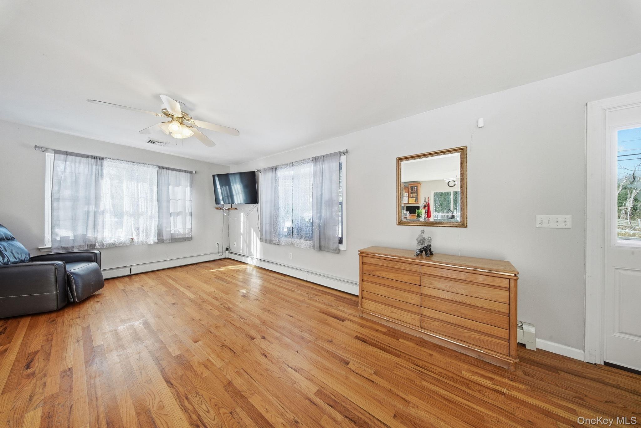 100 Maybrook Road Campbell Hall, NY 10916 - Photo 4 of 32 a spacious bedroom with a bed and a chandelier