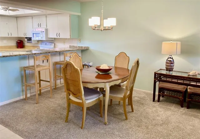 a dining room with furniture and a window