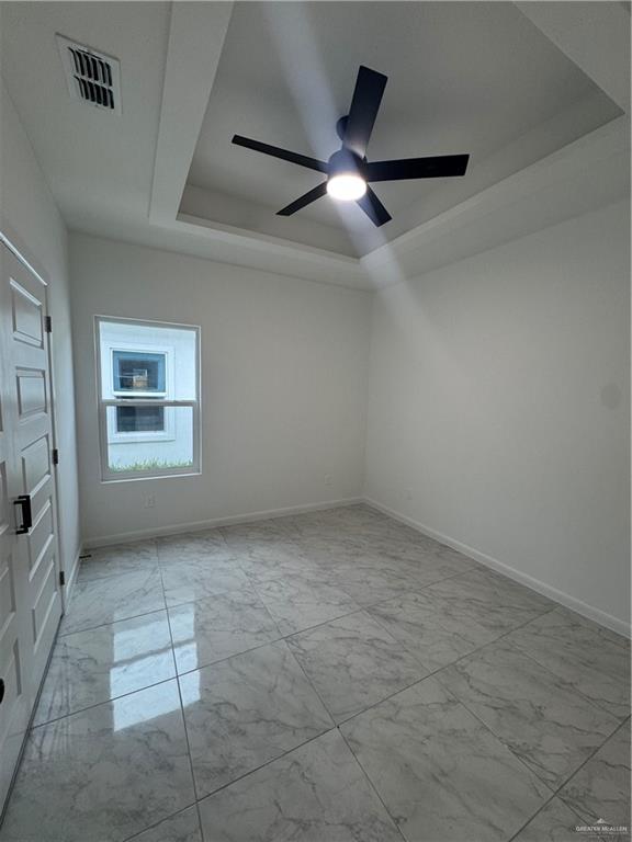 5804 Notre Dame Avenue, Unit 3 Mission, TX 78573 - Photo 11 of 12 an empty room with a ceiling fan and windows
