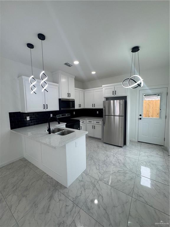 5804 Notre Dame Avenue, Unit 3 Mission, TX 78573 - Photo 3 of 12 a kitchen with stainless steel appliances granite countertop a sink a stove and refrigerator